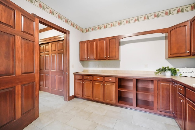 kitchen featuring light countertops and brown cabinetry