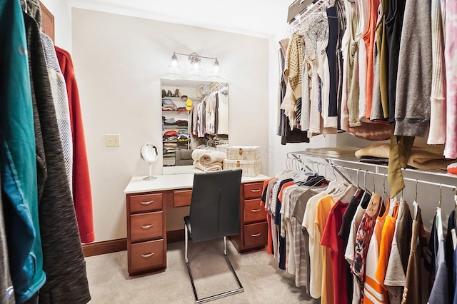 walk in closet featuring light colored carpet