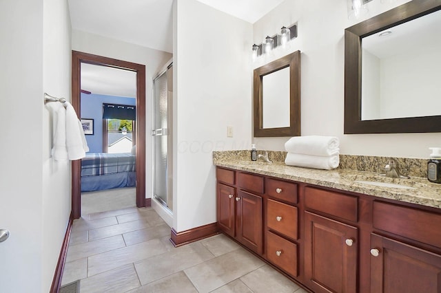 ensuite bathroom featuring a shower stall, a sink, ensuite bath, visible vents, and double vanity