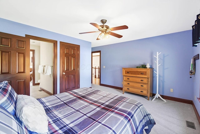 bedroom featuring baseboards, ceiling fan, visible vents, and light colored carpet
