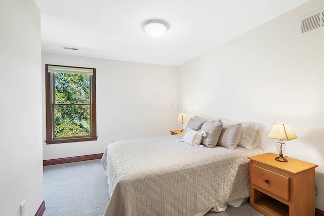 carpeted bedroom with baseboards and visible vents