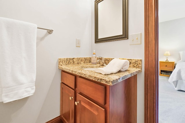 ensuite bathroom featuring connected bathroom and vanity