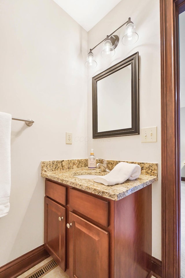 bathroom with baseboards and vanity