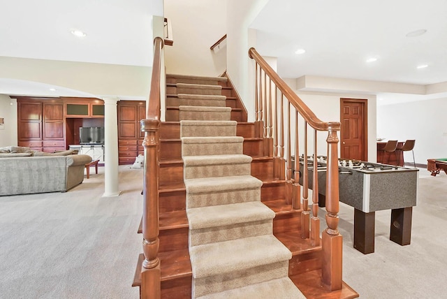 staircase featuring decorative columns, carpet floors, and recessed lighting