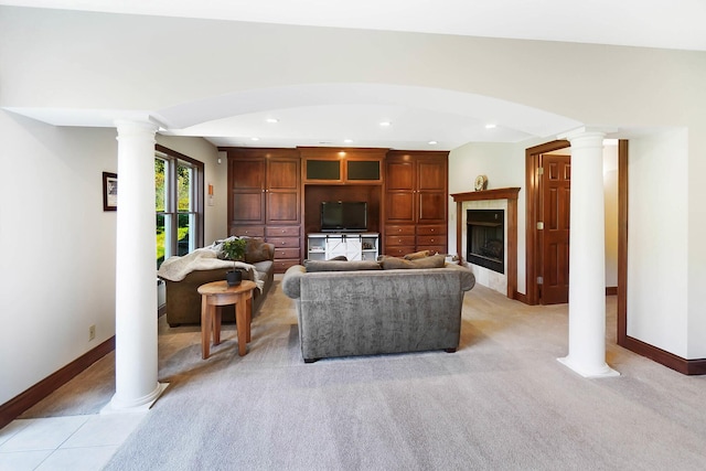 living area with ornate columns, baseboards, a fireplace, recessed lighting, and light carpet
