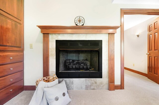 interior details featuring carpet floors, baseboards, and a fireplace