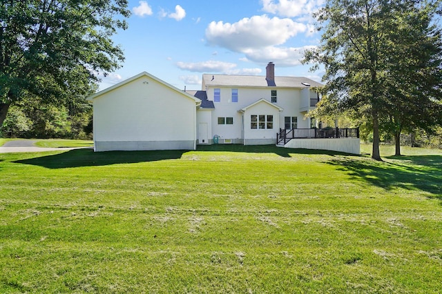 back of property with a lawn and a chimney