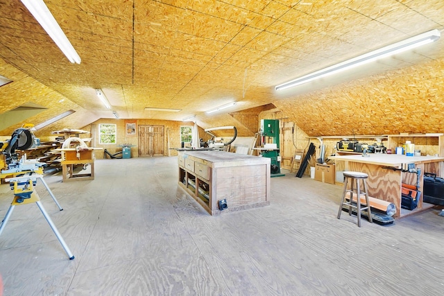 interior space featuring vaulted ceiling and a workshop area