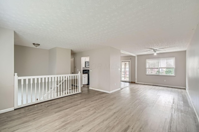 3104 Lewis Rd, Columbus, OH 43207 - unfurnished room featuring a textured ceiling, light wood-style floors, and a ceiling fan