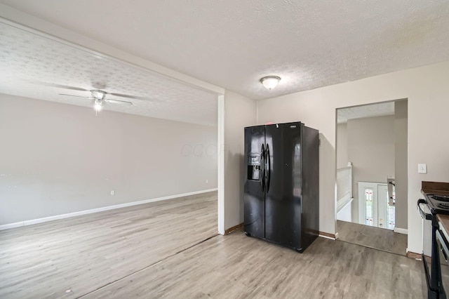 3104 Lewis Rd, Columbus, OH 43207 - kitchen featuring black appliances, a textured ceiling, light wood-style floors, and a ceiling fan