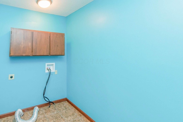 clothes washing area with baseboards, washer hookup, hookup for an electric dryer, and cabinet space