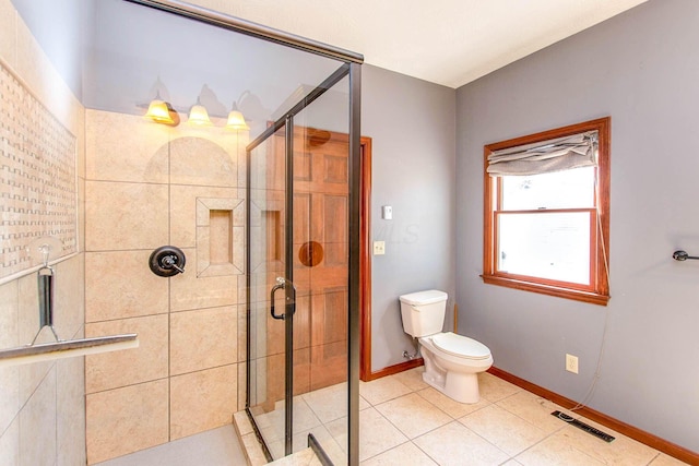 bathroom featuring a stall shower, baseboards, visible vents, and toilet