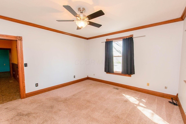 unfurnished room with baseboards, ceiling fan, ornamental molding, and carpet flooring
