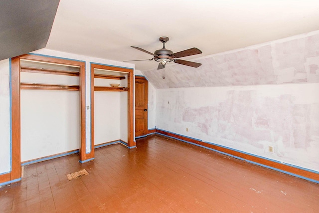 additional living space featuring baseboards, wood-type flooring, lofted ceiling, and a ceiling fan