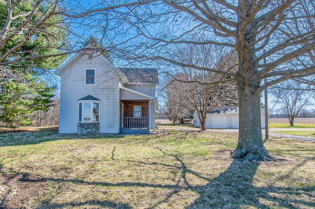 view of front of house with a front yard, a porch, and a garage