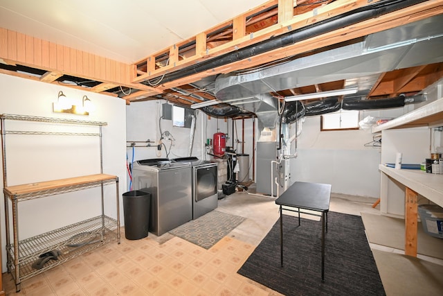 basement featuring heating unit and washer and clothes dryer