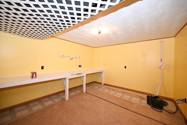 clothes washing area with light carpet and baseboards