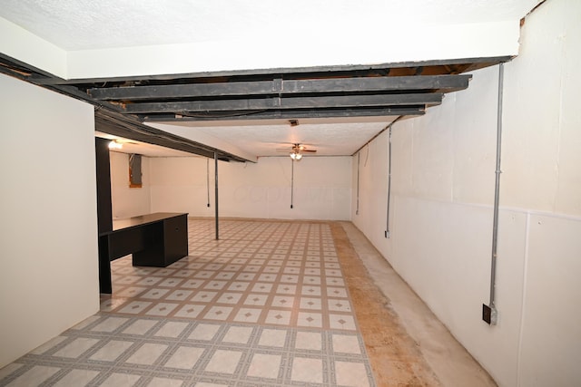 finished below grade area featuring light floors and a textured ceiling