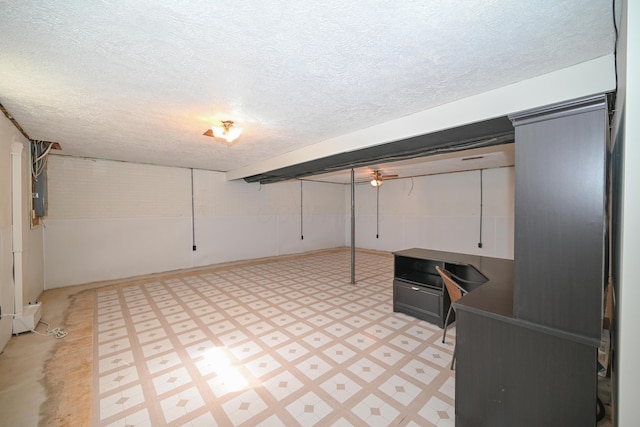 finished basement with light floors and a textured ceiling