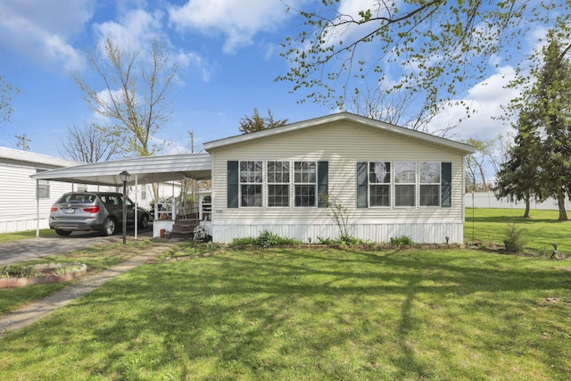 manufactured / mobile home with a front yard and concrete driveway