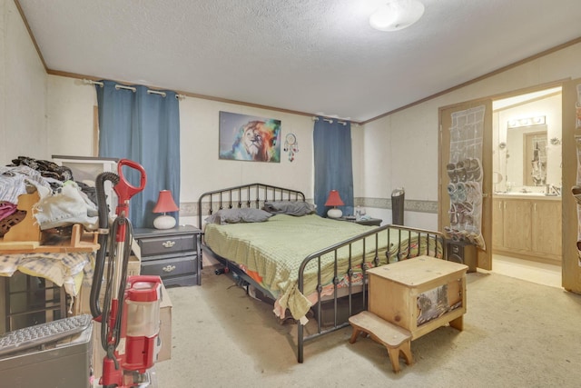bedroom featuring crown molding, ensuite bathroom, carpet flooring, and a textured ceiling