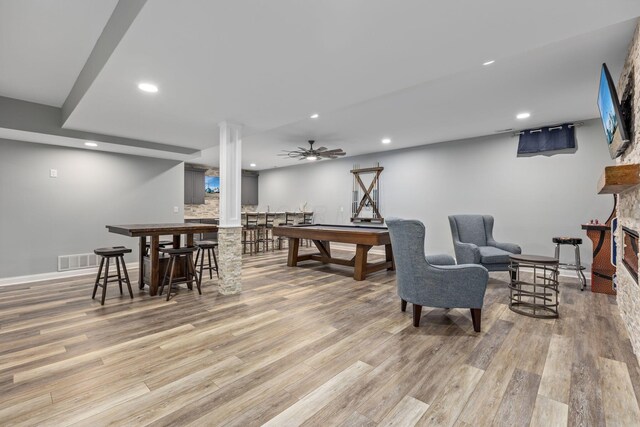 rec room with indoor bar, light wood-type flooring, visible vents, and recessed lighting