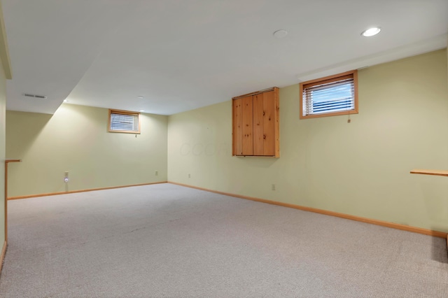 below grade area featuring visible vents, baseboards, carpet, and recessed lighting