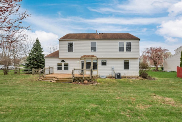 rear view of house featuring a yard, central AC unit, a deck, and fence