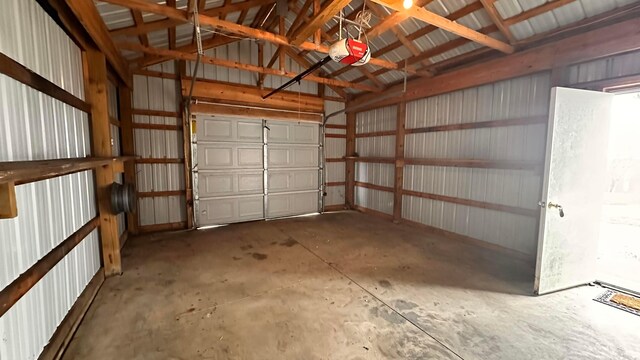 garage with metal wall and a garage door opener