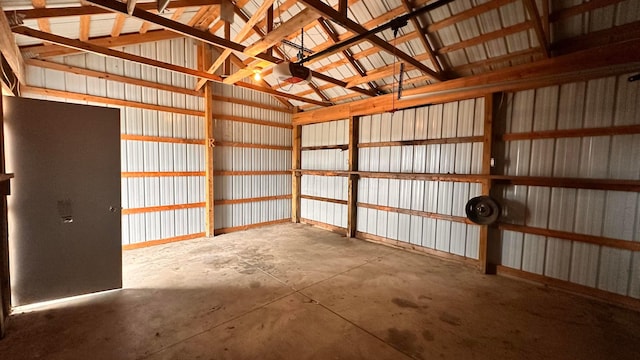 garage with metal wall and a garage door opener
