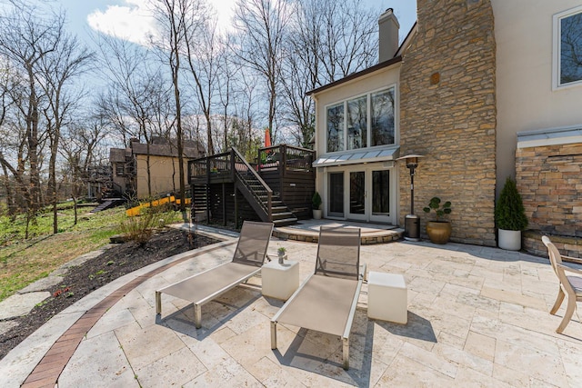 view of patio with a wooden deck, stairway, and french doors