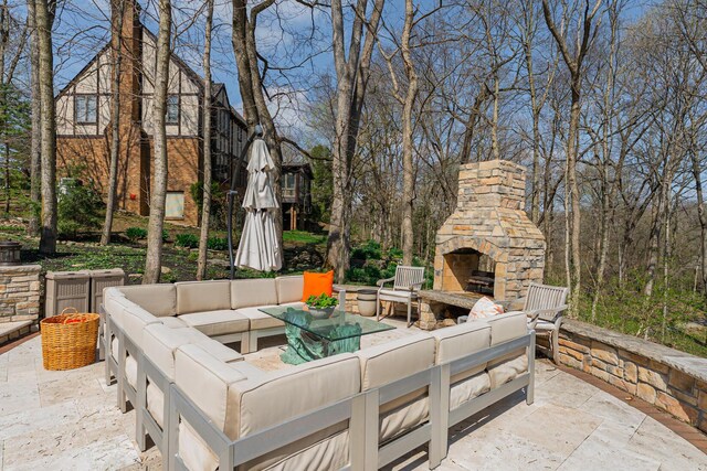 view of patio featuring an outdoor living space with a fireplace