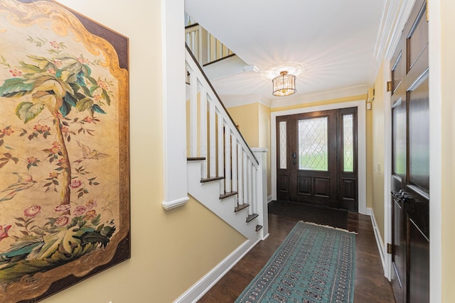 foyer with crown molding, baseboards, stairway, and dark wood-type flooring