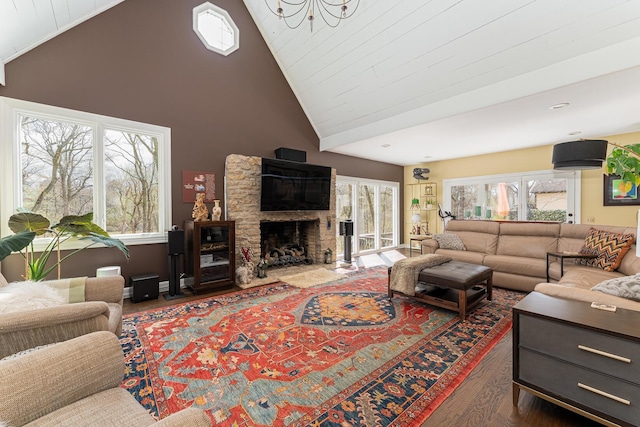 living room featuring high vaulted ceiling, a fireplace, and wood finished floors