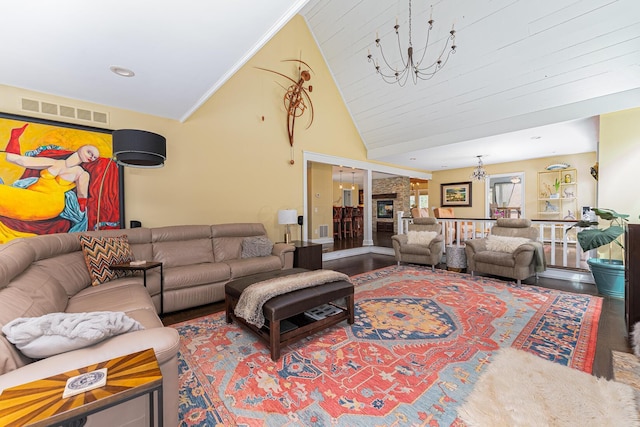 living area with vaulted ceiling, ornamental molding, visible vents, a notable chandelier, and wood finished floors