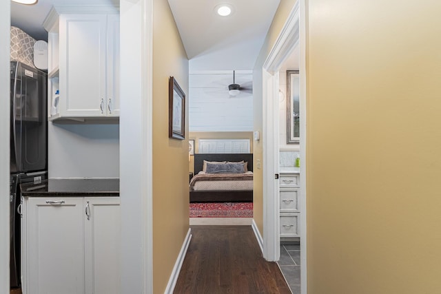 hallway with dark wood-style floors, baseboards, and recessed lighting
