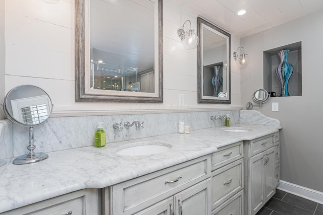 bathroom featuring decorative backsplash, double vanity, a sink, and tile patterned flooring