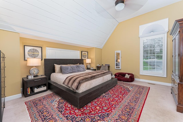 carpeted bedroom with baseboards and lofted ceiling