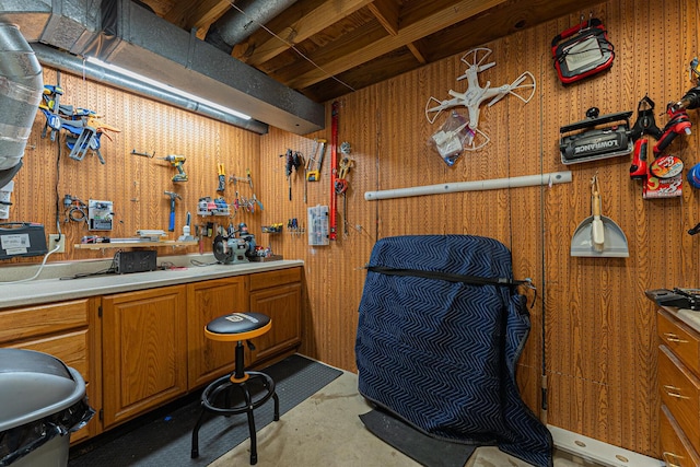 miscellaneous room with concrete floors and a workshop area