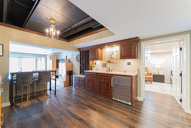 kitchen featuring a sink, dark wood-style floors, refrigerator, and an inviting chandelier