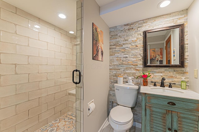 bathroom with toilet, vanity, a stall shower, and recessed lighting