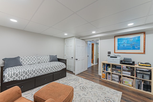 interior space with wood finished floors, a paneled ceiling, and recessed lighting