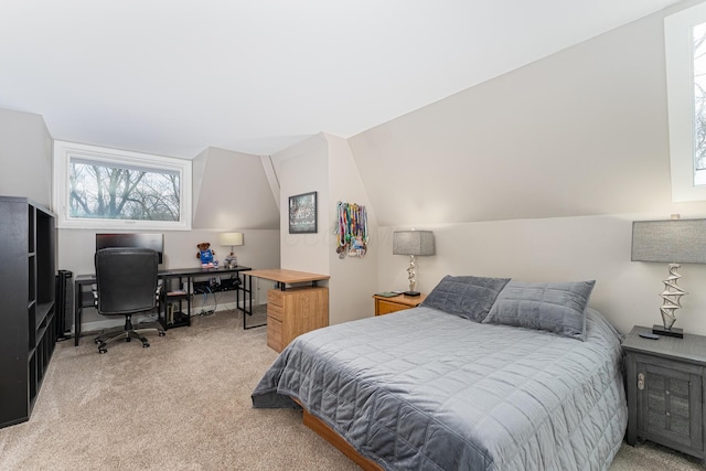 bedroom with vaulted ceiling and light colored carpet