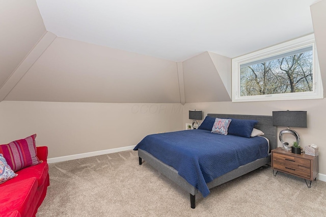 bedroom featuring baseboards, vaulted ceiling, and light carpet
