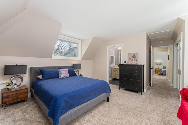 bedroom with baseboards, lofted ceiling, ensuite bath, and light carpet