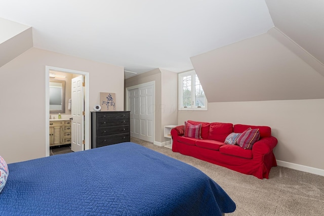 bedroom featuring baseboards, carpet flooring, connected bathroom, and vaulted ceiling