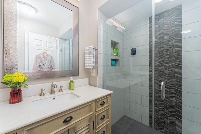 full bath with vanity and a shower stall