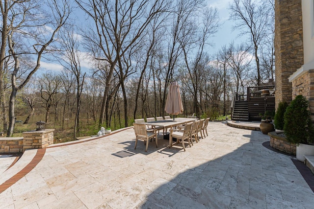 view of patio featuring outdoor dining space and stairway