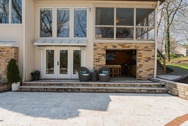 entrance to property with french doors and stucco siding
