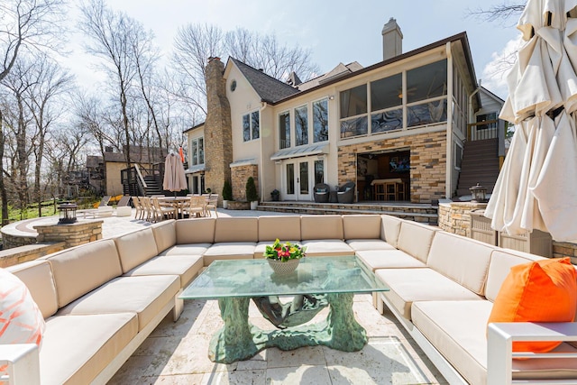 exterior space with an outdoor hangout area, outdoor dining area, stairway, and french doors